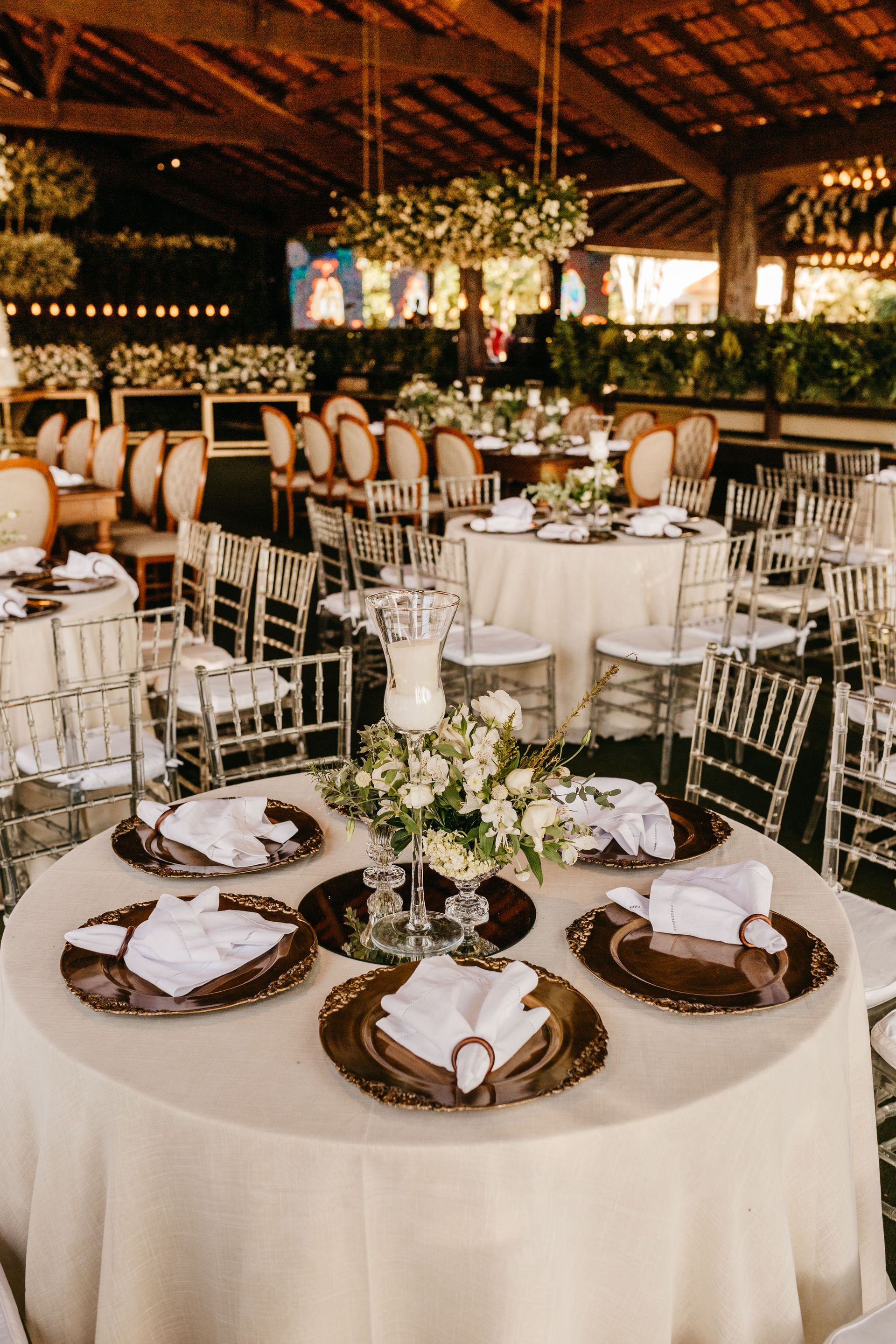 Beautifully arranged wedding reception with elegant table settings and floral decorations.